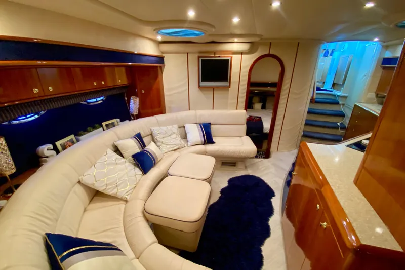  Yacht Photos Pics Luxurious interior of 1999 Neptunus 54 Hardtop Express yacht with plush seating and elegant decor.