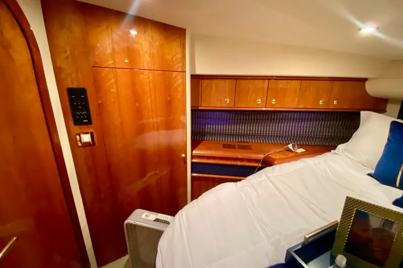  Yacht Photos Pics Luxurious cabin interior of 1999 Neptunus 54 Hardtop Express yacht with wood paneling.