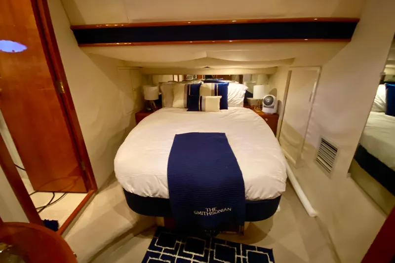  Yacht Photos Pics Luxurious cabin interior of 1999 Neptunus 54 Hardtop Express yacht with cozy bedding.