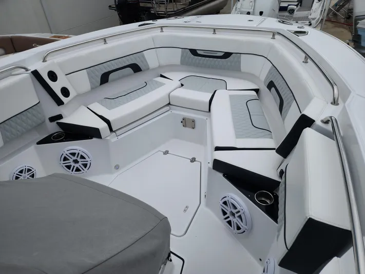  Yacht Photos Pics 2023 Blackfin 272 CC boat interior with cushioned seating and speakers.