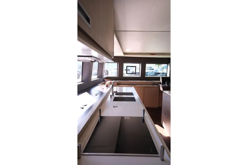  Yacht Photos Pics Modern kitchen interior of 2020 Lagoon 630 MY yacht with sleek design and ample lighting.