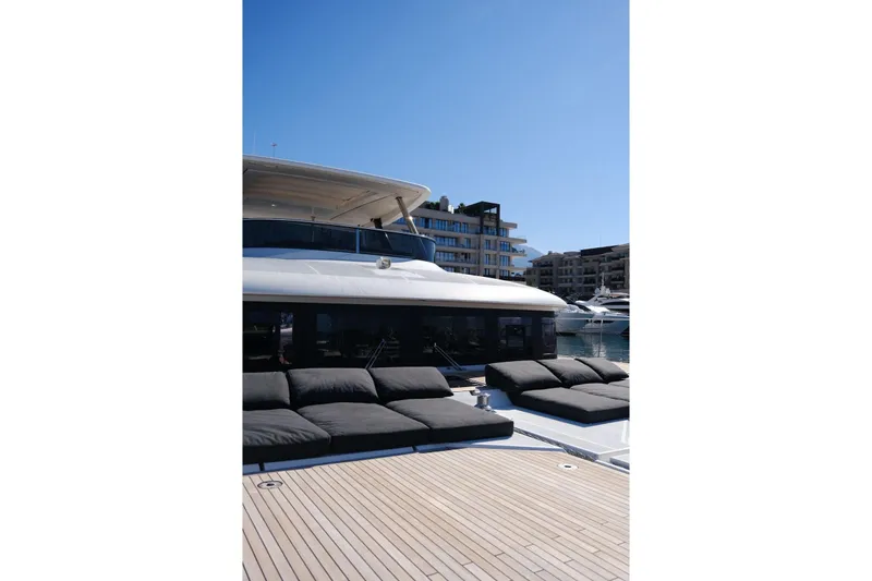  Yacht Photos Pics Luxurious 2020 Lagoon 630 MY yacht with sun loungers, docked in a marina.