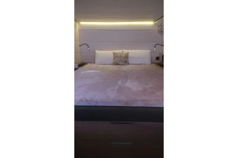  Yacht Photos Pics Luxurious bedroom interior of 2020 Lagoon 630 MY yacht with modern lighting.