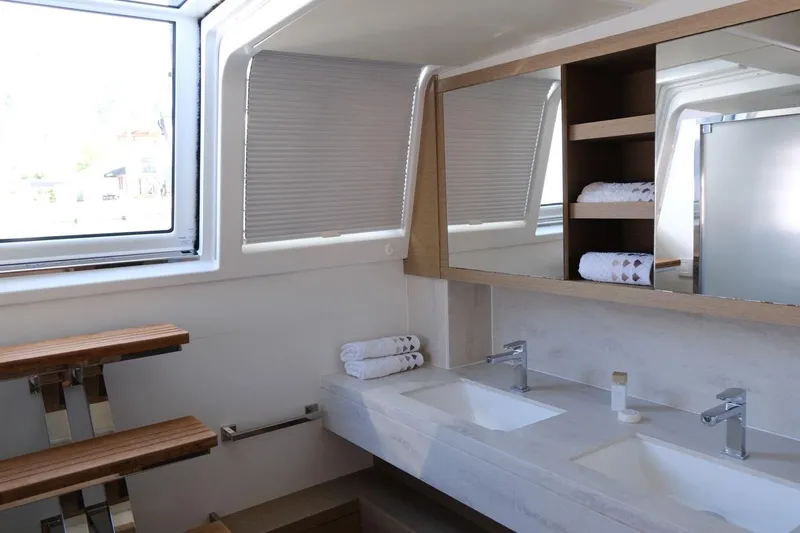  Yacht Photos Pics Luxurious bathroom in 2020 Lagoon 630 MY yacht with dual sinks and modern design.