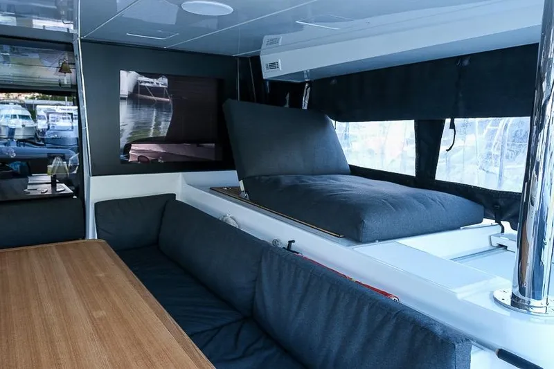  Yacht Photos Pics Interior of 2020 Lagoon 630 MY yacht with modern seating and wooden table.