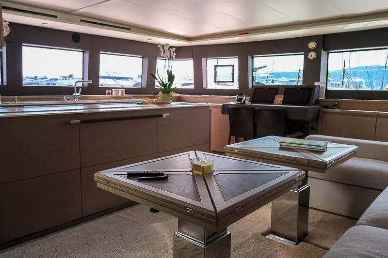  Yacht Photos Pics Luxurious interior of 2020 Lagoon 630 MY yacht with modern furnishings and panoramic windows.