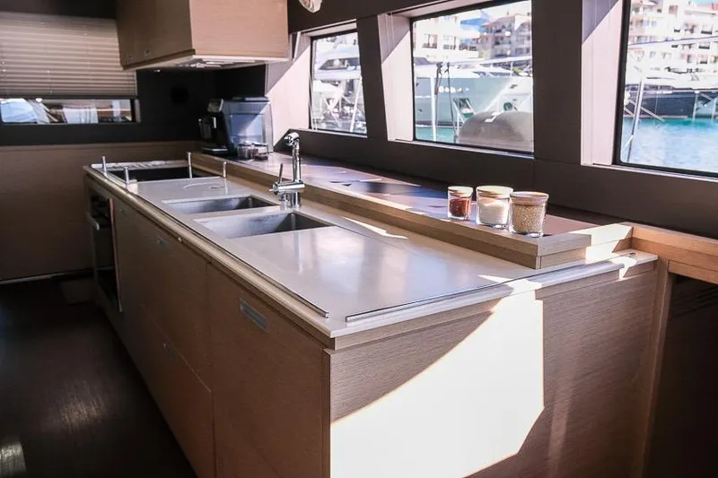  Yacht Photos Pics Modern kitchen interior of 2020 Lagoon 630 MY yacht with sleek countertops and large windows.