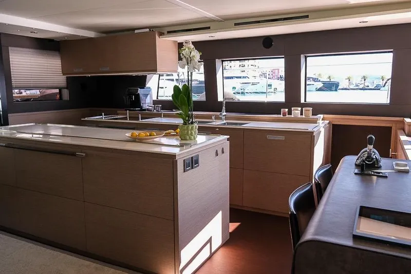  Yacht Photos Pics Luxurious interior of 2020 Lagoon 630 MY yacht with modern kitchen and dining area.