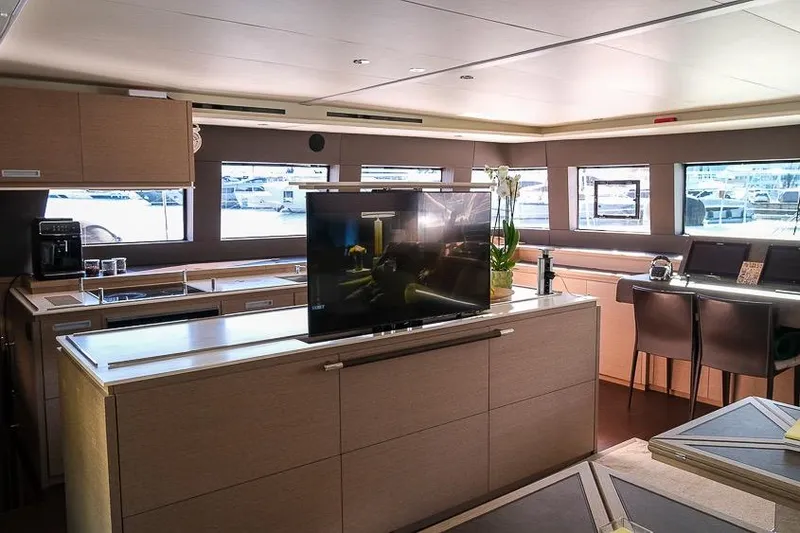  Yacht Photos Pics Luxurious interior of 2020 Lagoon 630 MY yacht with modern kitchen and seating area.