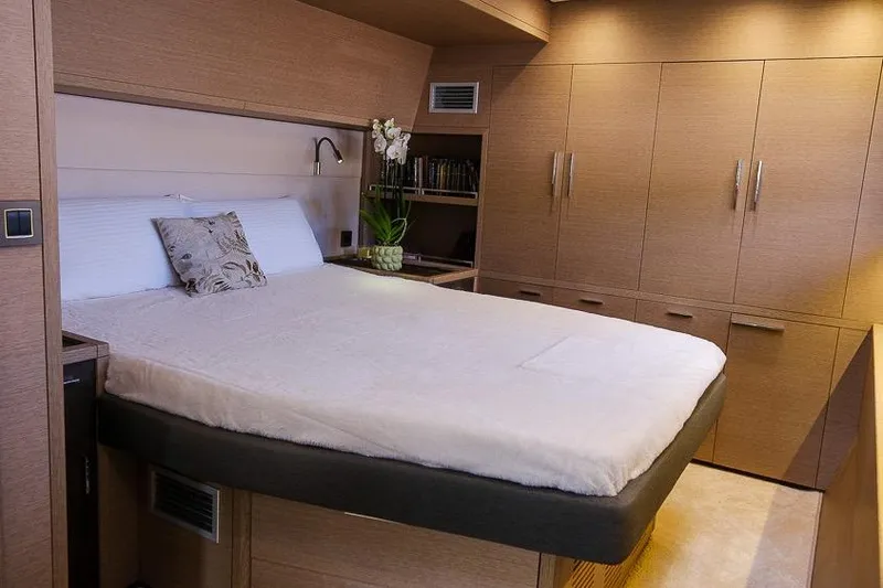  Yacht Photos Pics Luxurious bedroom interior of 2020 Lagoon 630 MY yacht with modern wood finishes.