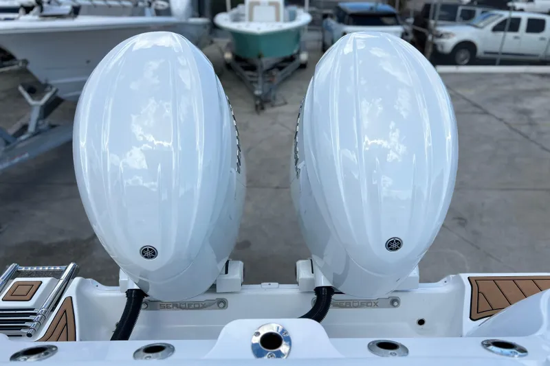  Yacht Photos Pics 2026 Sea Fox 268 Commander with dual outboard engines, docked in a marina.