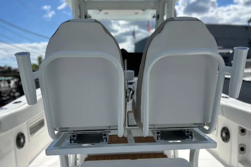  Yacht Photos Pics 2026 Sea Fox 268 Commander boat seats with rod holders, under a sunny sky.