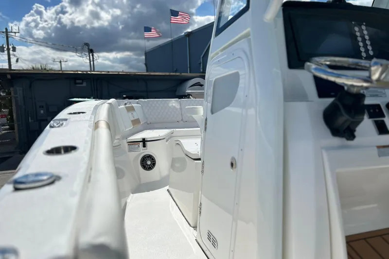  Yacht Photos Pics 2026 Sea Fox 268 Commander boat interior with steering console and seating under cloudy sky.