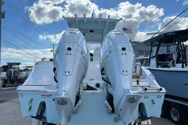  Yacht Photos Pics 2026 Sea Fox 268 Commander with dual outboard engines, docked under a partly cloudy sky.