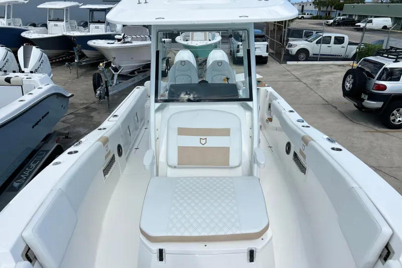 Yacht Photos Pics 2026 Sea Fox 268 Commander boat interior with seating and console, parked in a marina.
