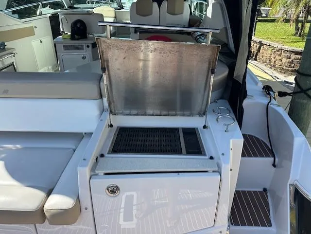 Namaste III Yacht Photos Pics Outdoor grill on 2010 Four Winns V435 yacht deck, open lid, seating area visible.