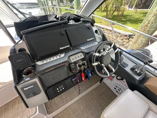 Namaste III Yacht Photos Pics 2010 Four Winns V435 helm with Raymarine electronics and modern steering wheel.