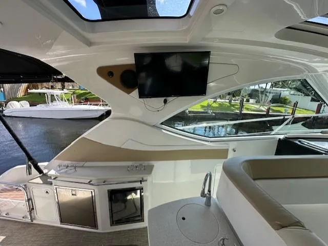 Namaste III Yacht Photos Pics Interior of 2010 Four Winns V435 yacht with TV and seating area.