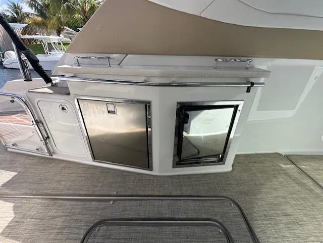 Namaste III Yacht Photos Pics 2010 Four Winns V435 yacht interior with stainless steel appliances and beige flooring.