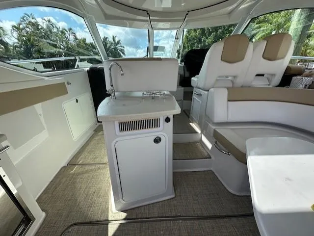 Namaste III Yacht Photos Pics 2010 Four Winns V435 yacht interior with seating, kitchenette, and helm.