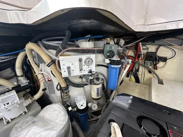 Namaste III Yacht Photos Pics Engine room of 2010 Four Winns V435 boat with various mechanical components and hoses.