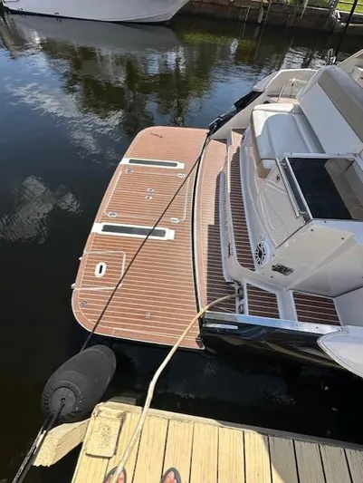 Namaste III Yacht Photos Pics 2010 Four Winns V435 yacht docked, featuring a spacious swim platform and sleek design.