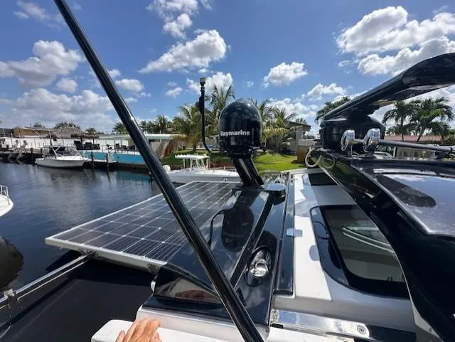 Namaste III Yacht Photos Pics 2010 Four Winns V435 yacht with solar panels and Raymarine equipment, docked under a sunny sky.
