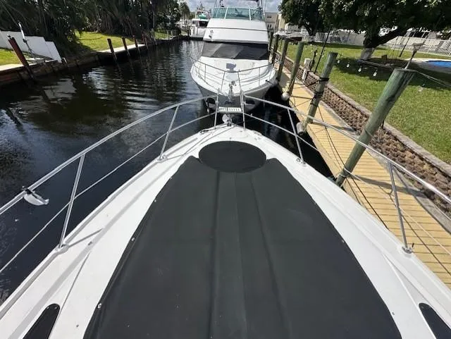 Namaste III Yacht Photos Pics 2010 Four Winns V435 yacht docked in a narrow canal, view from the bow.