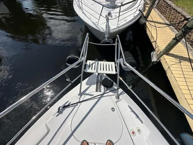 Namaste III Yacht Photos Pics Bow view of 2010 Four Winns V435 yacht docked near another boat.