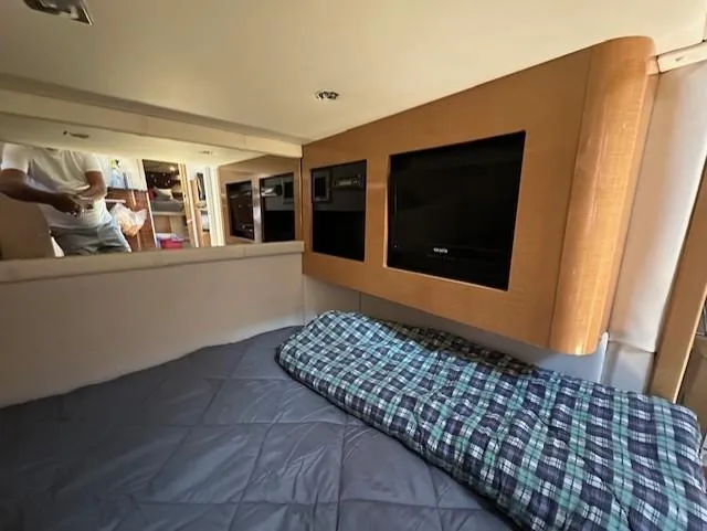 Namaste III Yacht Photos Pics Interior of 2010 Four Winns V435 yacht with cozy bedding and entertainment system.