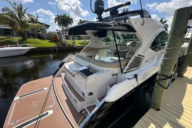 Namaste III Yacht Photos Pics 2010 Four Winns V435 yacht docked, featuring spacious deck and modern design.