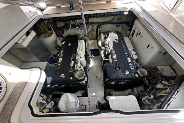 Namaste III Yacht Photos Pics Engine compartment of 2010 Four Winns V435 boat, showcasing dual engines and mechanical components.