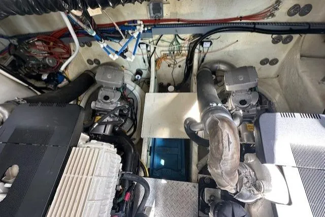 Namaste III Yacht Photos Pics Engine room of 2010 Four Winns V435 boat, showcasing dual engines and mechanical components.