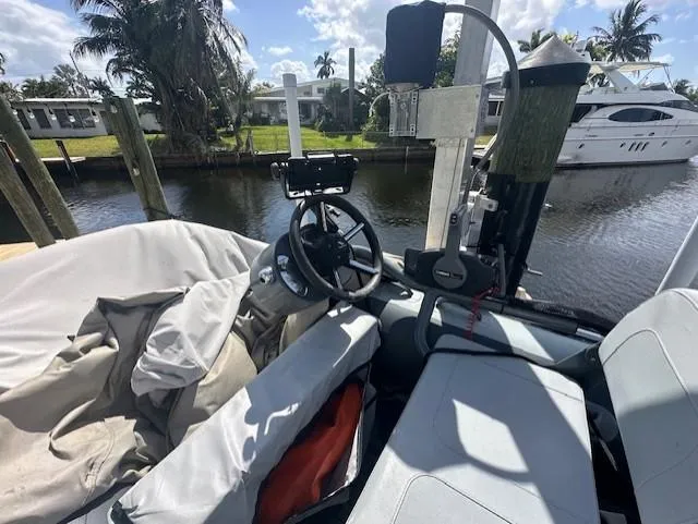 Namaste III Yacht Photos Pics 2010 Four Winns V435 boat interior with steering wheel, docked by a canal.