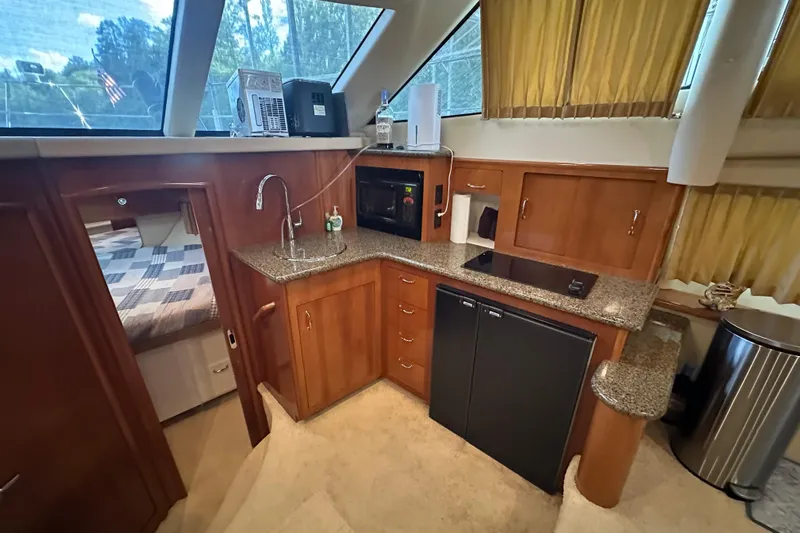  Yacht Photos Pics 2005 Carver 41 Cockpit Motor Yacht interior with kitchenette and bedroom view.