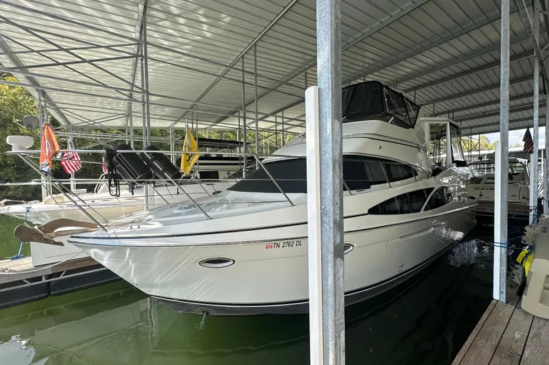  Yacht Photos Pics 2005 Carver 41 Cockpit Motor Yacht docked in a covered marina.