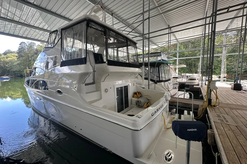  Yacht Photos Pics 2005 Carver 41 Cockpit Motor Yacht docked in a covered marina.