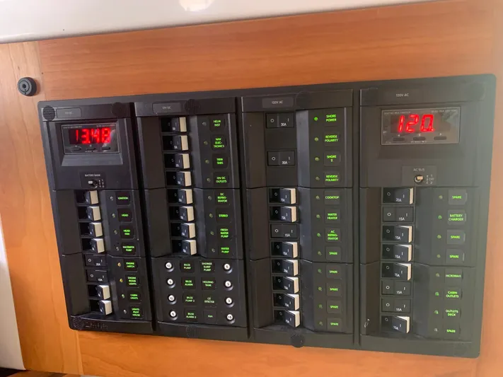  Yacht Photos Pics Electrical panel of a 2016 Back Cove 30 boat, featuring multiple switches and digital displays.