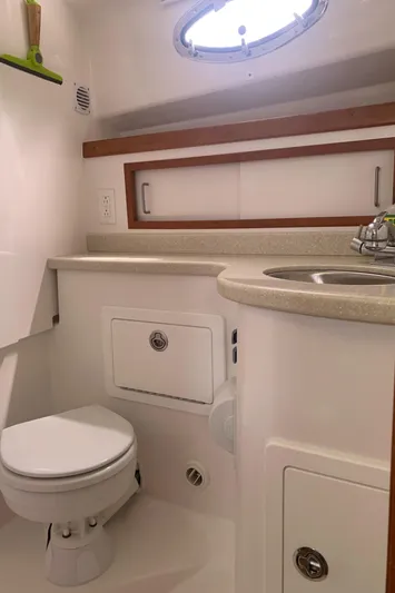  Yacht Photos Pics 2016 Back Cove 30 boat bathroom with sink, toilet, and storage cabinets.