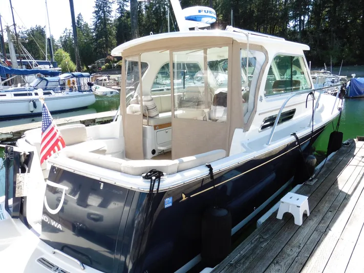  Yacht Photos Pics 2016 Back Cove 30 boat docked, featuring a sleek design and American flag.