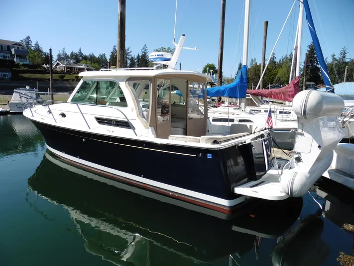  Yacht Photos Pics 2016 Back Cove 30 boat docked in a marina, featuring a sleek design and spacious cabin.