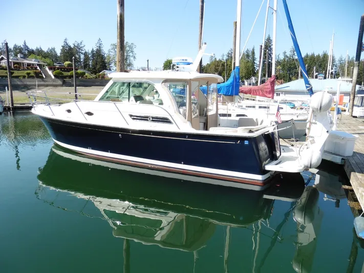 Yacht Photos Pics 2016 Back Cove 30 boat docked in a marina, featuring a sleek design and blue hull.