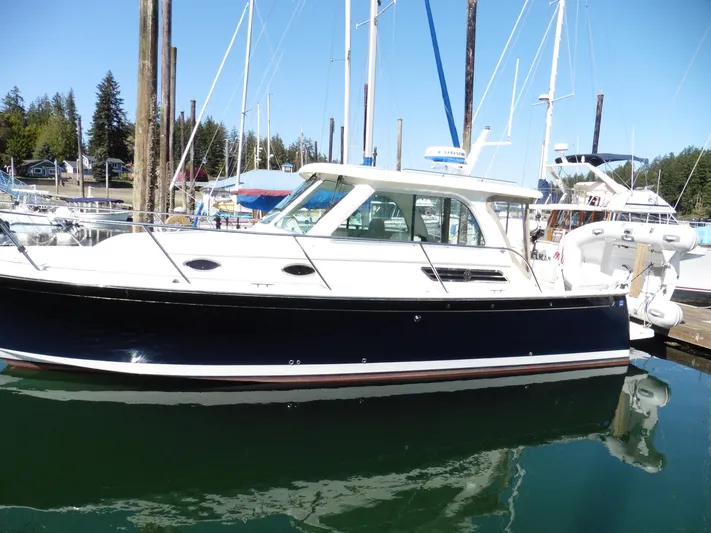  Yacht Photos Pics 2016 Back Cove 30 boat docked in a marina, featuring a sleek black and white design.