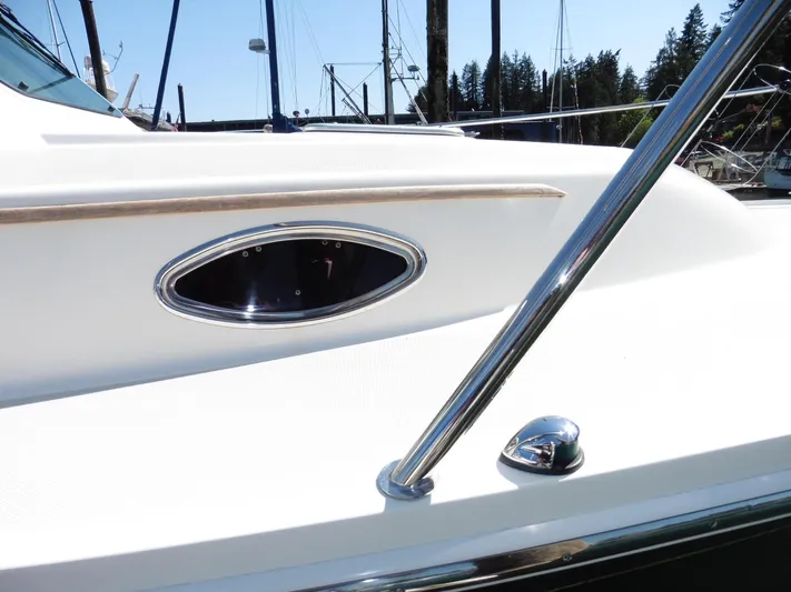  Yacht Photos Pics 2016 Back Cove 30 boat detail with chrome railing and oval window.