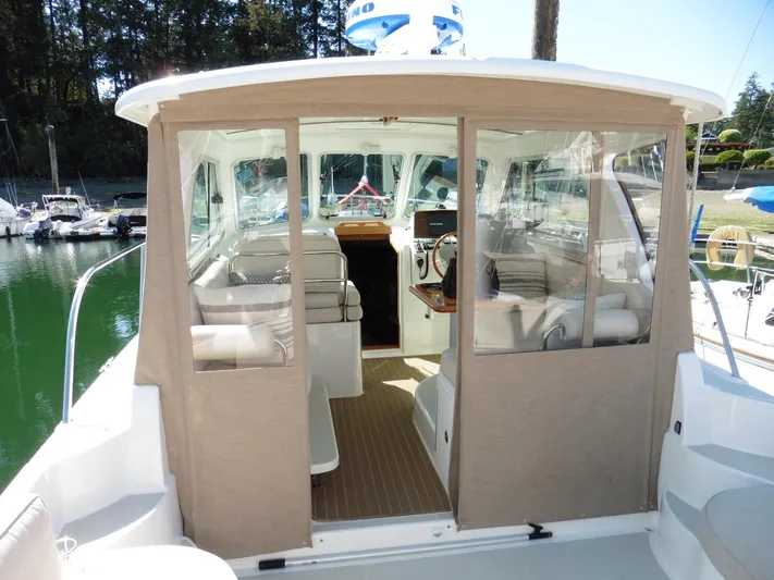  Yacht Photos Pics 2016 Back Cove 30 boat interior with seating and helm, docked in a marina.