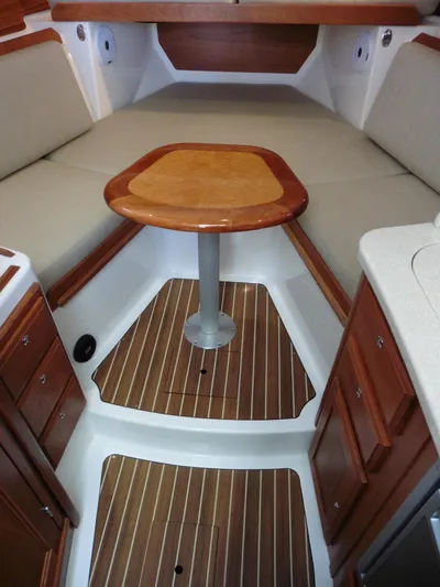  Yacht Photos Pics 2016 Back Cove 30 interior with wood table, cushioned seating, and elegant cabinetry.