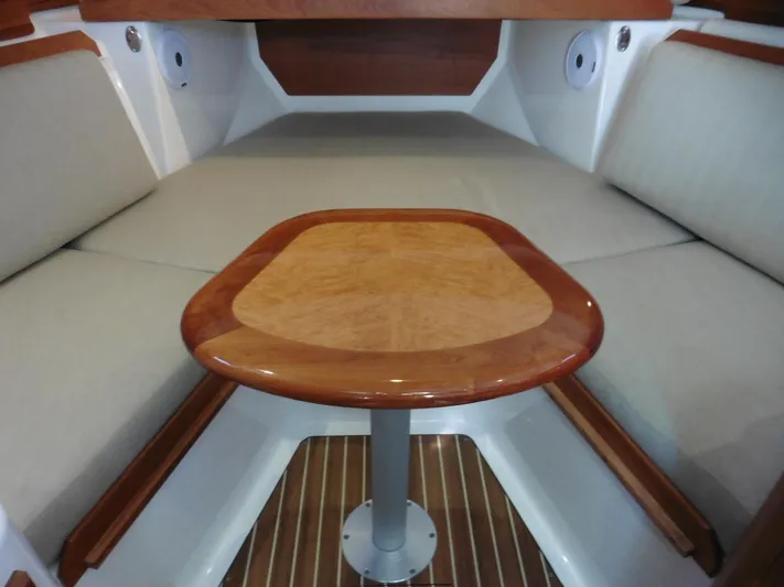  Yacht Photos Pics 2016 Back Cove 30 interior with wooden table and cushioned seating.