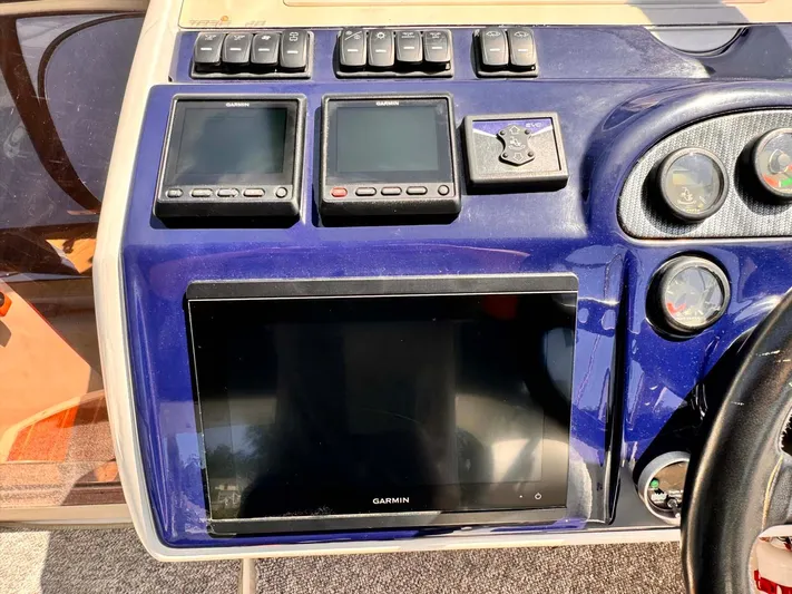 Pave The Wave VII Yacht Photos Pics Control panel of a 2005 Fairline Targa 40 yacht with Garmin displays.