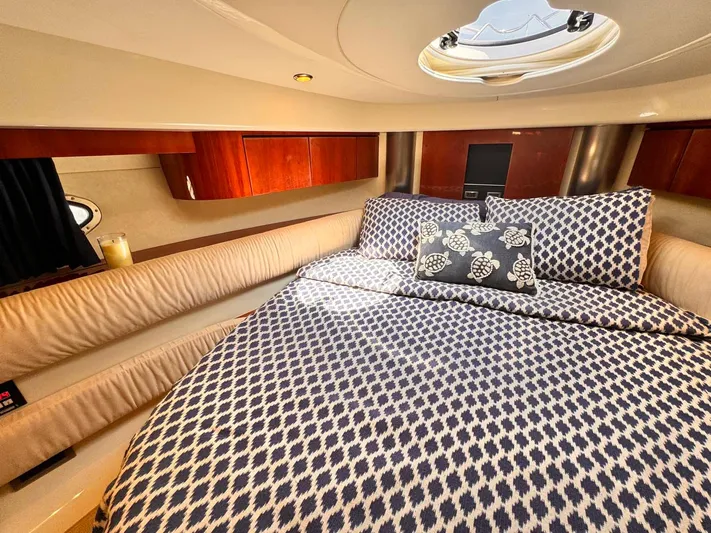Pave The Wave VII Yacht Photos Pics Luxurious cabin interior of 2005 Fairline Targa 40 yacht with patterned bedding.
