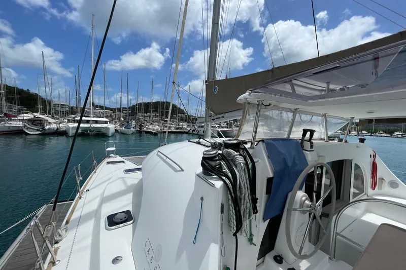 Carnabie Yacht Photos Pics 2014 Lagoon 380 S2 catamaran docked in a marina under a blue sky.